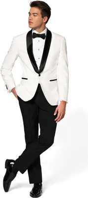 A man wearing a white tuxedo with black lapels and a black bow tie, posing against a white background.