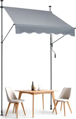 A patio awning set up over a small table and two chairs.