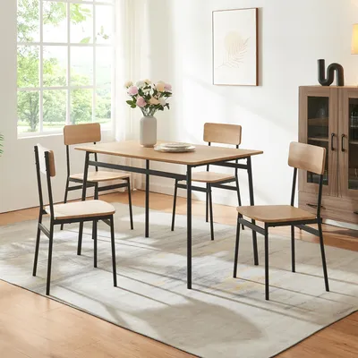 A dining set with a table and four chairs in a well-lit room with a large window.