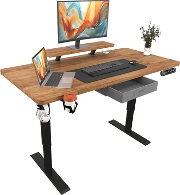 A standing desk setup with a laptop, monitor, keyboard, and accessories.