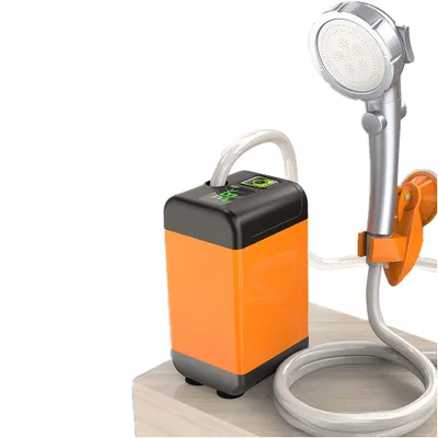 A portable camping shower with a pump and shower head, placed on a wooden surface.