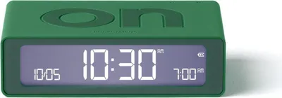 A green digital alarm clock with a digital display showing the time and alarm settings.