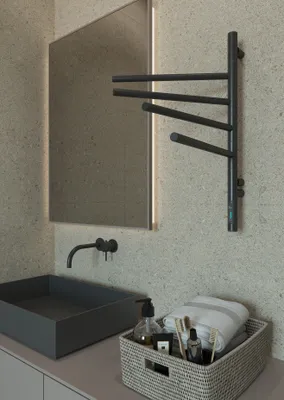 A modern bathroom scene featuring a sink, faucet, mirror, and a towel warmer.