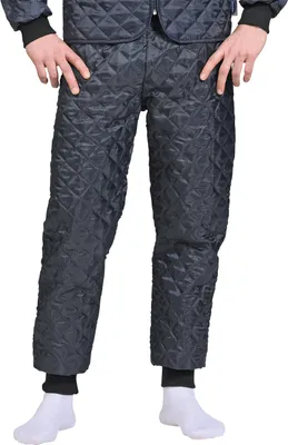 A person wearing quilted blue trousers and white socks.