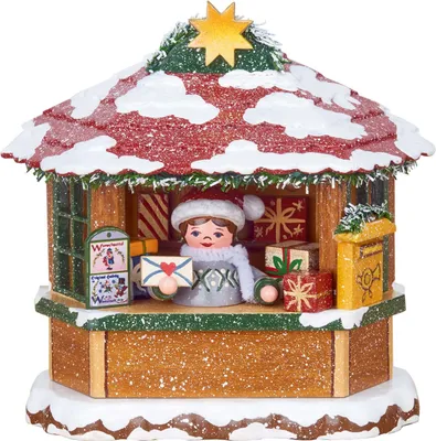 A festive, snow-covered Christmas market stall with a figure holding an envelope.
