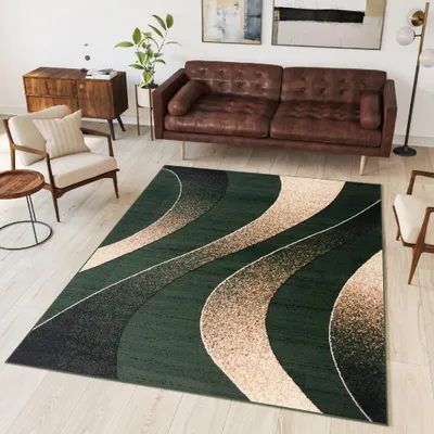 A living room scene with a rug, sofa, armchair, and side table.