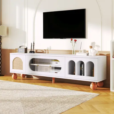 A modern living room with a TV mounted on the wall above a white TV stand.
