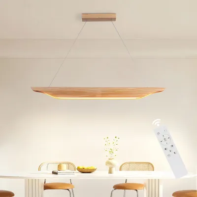 A modern wooden pendant light hangs over a dining table.