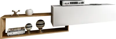 A modern, wall-mounted TV lowboard with a white cabinet and a wooden shelf section, decorated with various objects.