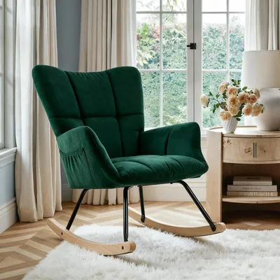 A green rocking chair is placed on a white rug in a well-lit room with a window in the background.