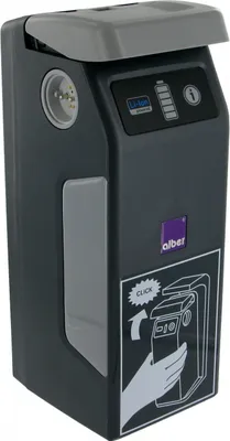 A dark gray electric wheelchair drive unit with a light gray lid and a diagram on the side.
