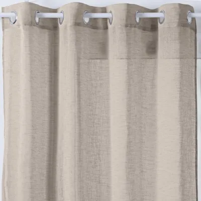 A close-up view of a beige curtain with grommets.