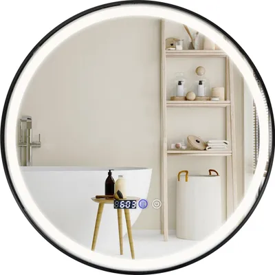 A modern bathroom with a round LED mirror, bathtub, shelving unit, and laundry basket.