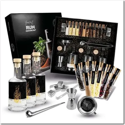 A rum making set with bottles, spices, and accessories, presented in a box.