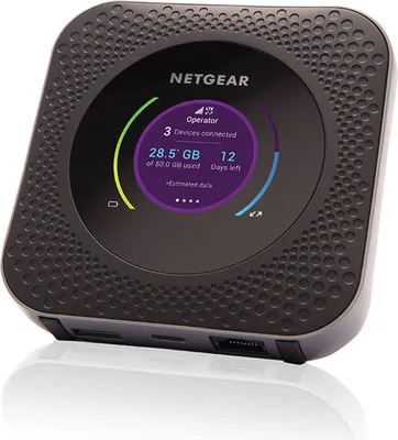 A black Netgear Nighthawk M1 mobile hotspot router is shown from a slightly low angle, reflecting on a white surface.