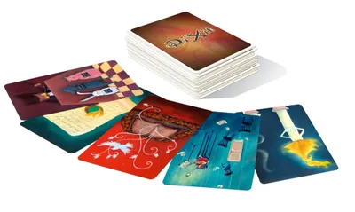 A stack of Dixit cards with several cards spread out in front of them.