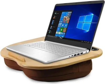 A silver laptop is placed on a brown and wood lap desk with a cup holder.