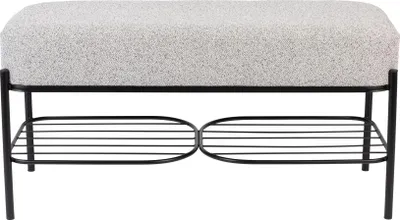 A product shot of a bench with a textured gray seat and a black metal frame, featuring a lower shelf with horizontal slats.