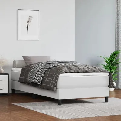 A bedroom scene with a bed, nightstand, and artwork.