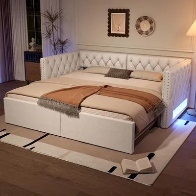 A tufted daybed with storage drawers and LED lighting in a bedroom setting.