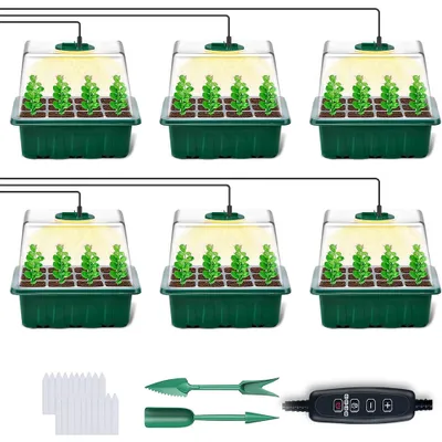 Six mini greenhouses with grow lights, along with gardening tools and markers.