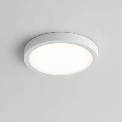 A white, round LED ceiling light is mounted on a light gray ceiling.