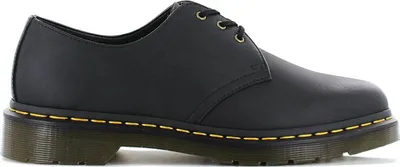 A side view of a black Dr. Martens shoe.