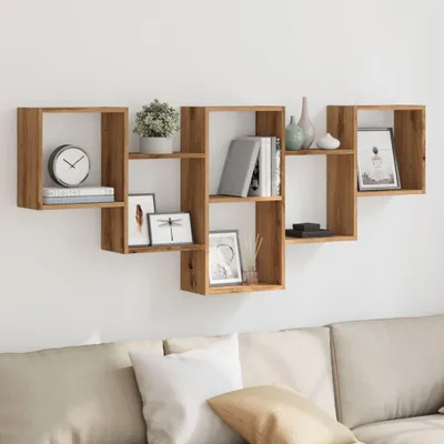 A wall-mounted shelf unit with various decorative items and books, placed above a couch.