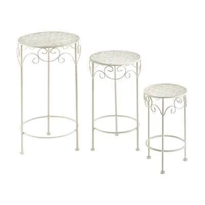 Three white metal plant stands of varying heights are arranged on a white background.