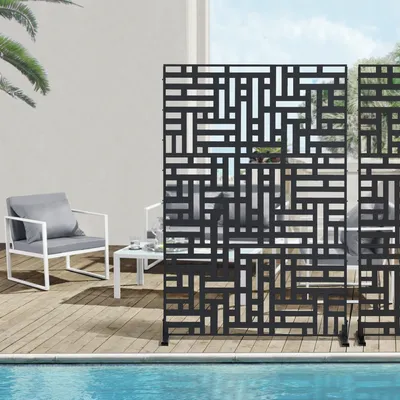 An outdoor patio scene with a pool, furniture, and decorative screens.