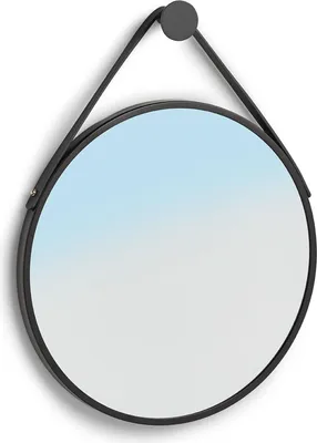 A round mirror with a black frame and a black strap hanging from a hook.