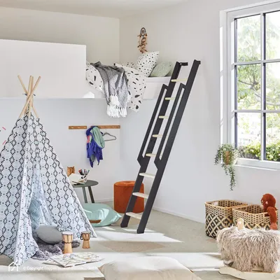 A child's bedroom with a loft bed, a teepee tent, and various decorative items.