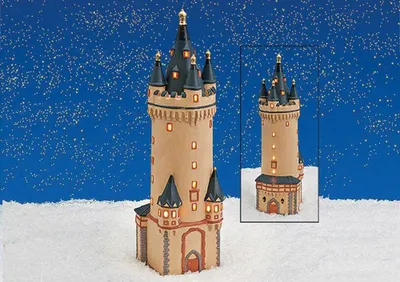 A miniature replica of the Eschenheimer Turm in Frankfurt, Germany, displayed in a snowy, winter-themed setting with a starry blue background.