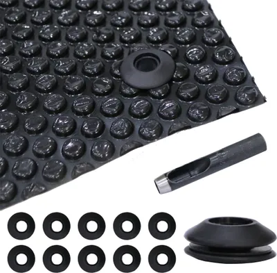 A collection of black grommets and a hole punch tool are laid out on a white background, with a section of bubble wrap in the upper left corner.