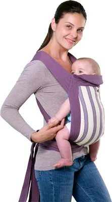 A woman is holding a baby in a baby carrier.