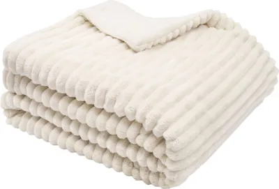 A folded cream-colored blanket with a ribbed texture is shown against a white background.