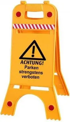 A yellow warning sign with black text and a black triangle with an exclamation mark.