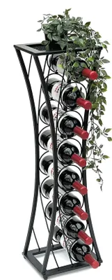 A black metal wine rack filled with red wine bottles, topped with a potted plant and trailing ivy.