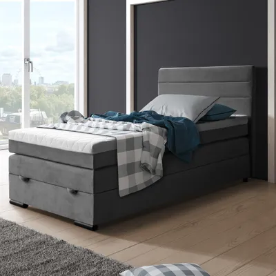 A bedroom scene with a bed, window, and wall.