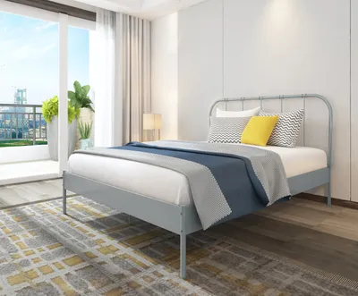 A bedroom scene with a bed, pillows, and a blanket.
