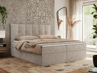 A bedroom scene featuring a large bed with bedding, a mirror, and decorative elements.