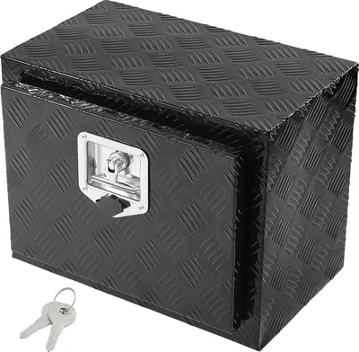 A black metal toolbox with a diamond plate texture sits on a white background. Two keys are placed in front of the toolbox.