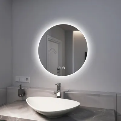 A modern bathroom sink area with a lit mirror.