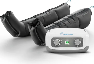 A compression therapy device with leg cuffs and a control unit, presented on a white background.