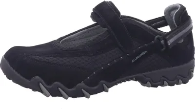 A black women's shoe is shown from the side against a white background.