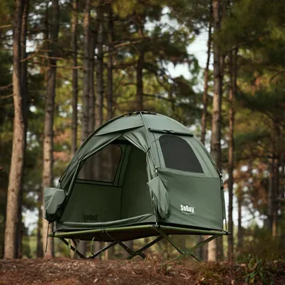 A green camping tent set up in a forest.