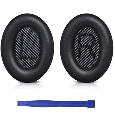 Two black ear pads for headphones and a blue plastic tool.