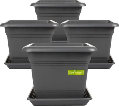 A group of four dark gray square planters with matching saucers are arranged in a staggered formation against a white background.