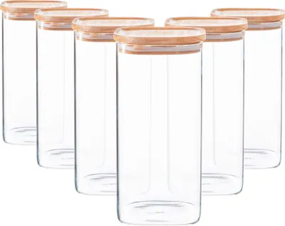 A set of six clear glass storage jars with wooden lids, arranged in a staggered formation against a white background.
