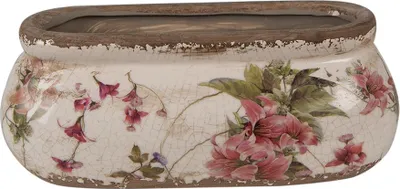 A ceramic planter with a floral design.
